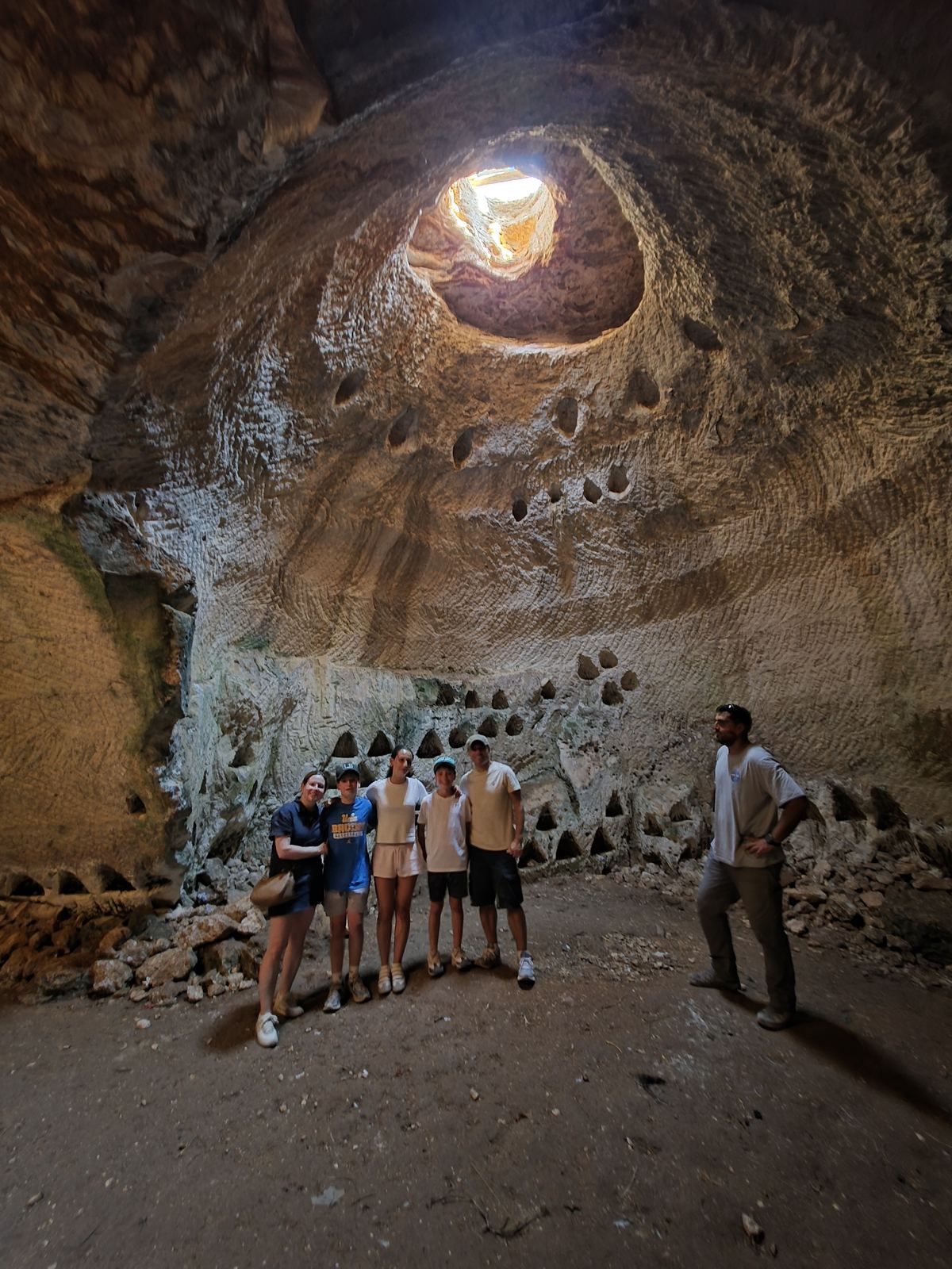 Family standing in a columbarium cave